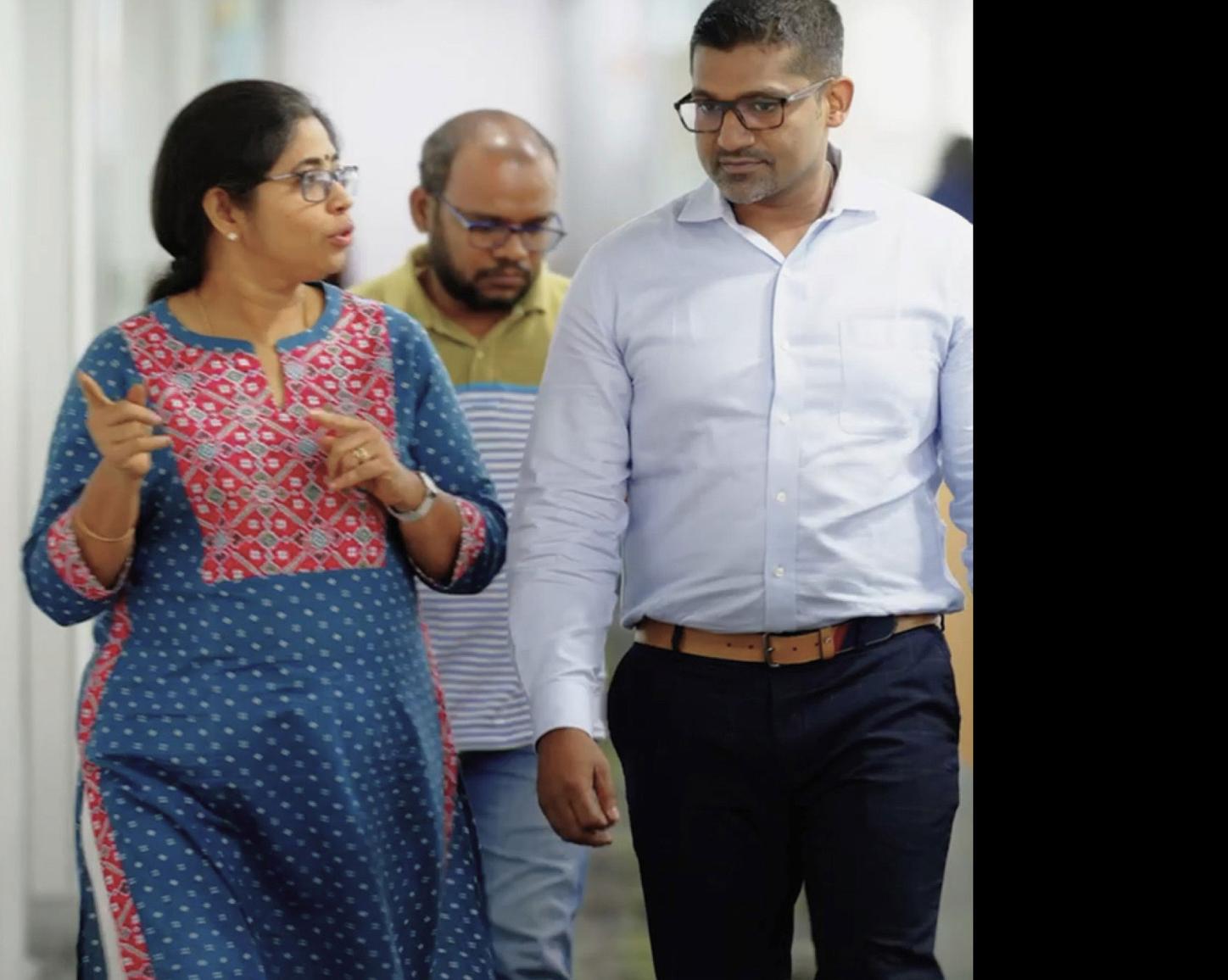 Colleagues in India walking through offices