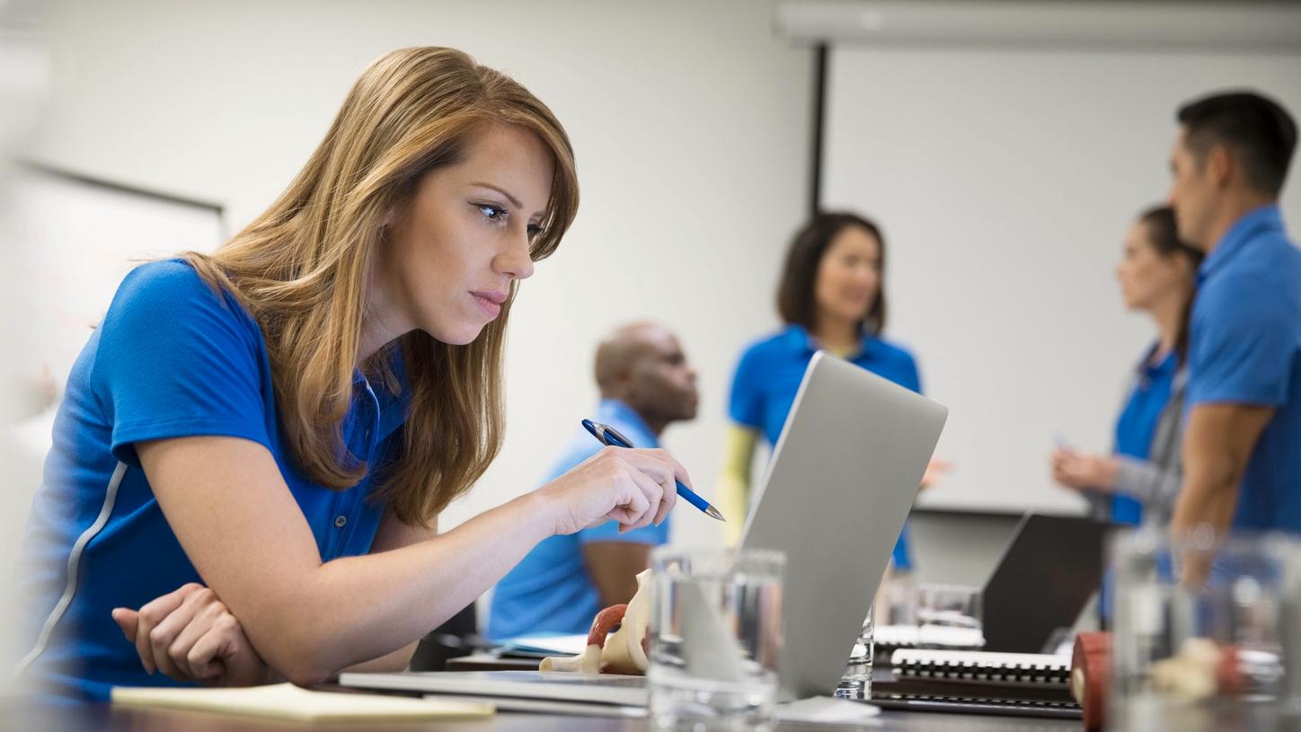 Female professional watching webinar on a laptop