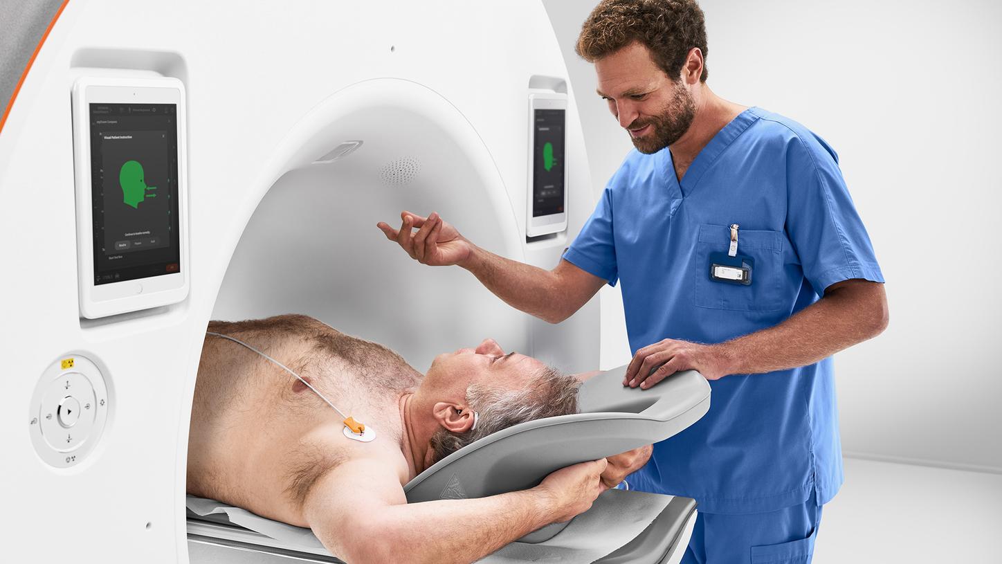 Technician shows the patient where the patient’s instructions are displayed during the scan, e.g., a countdown helps the patient hold their breath for a short time.